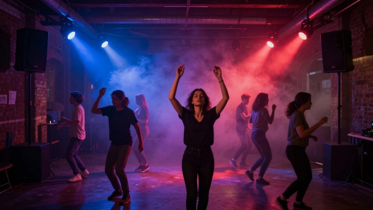 Dancefloor bathed in red and indigo light, people moving to deep bass under pulsing beams in a historic brick venue.